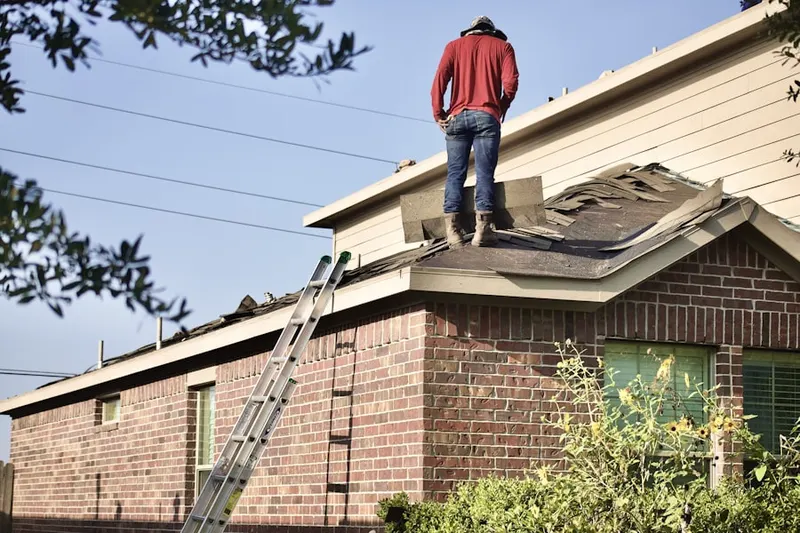 Professional roofer working on a residential roof in Madisonville